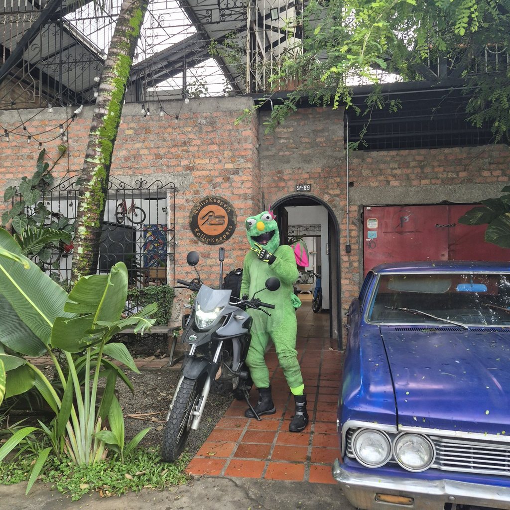 Fluffy with his motorcycle in a brick courtyard in Colombia